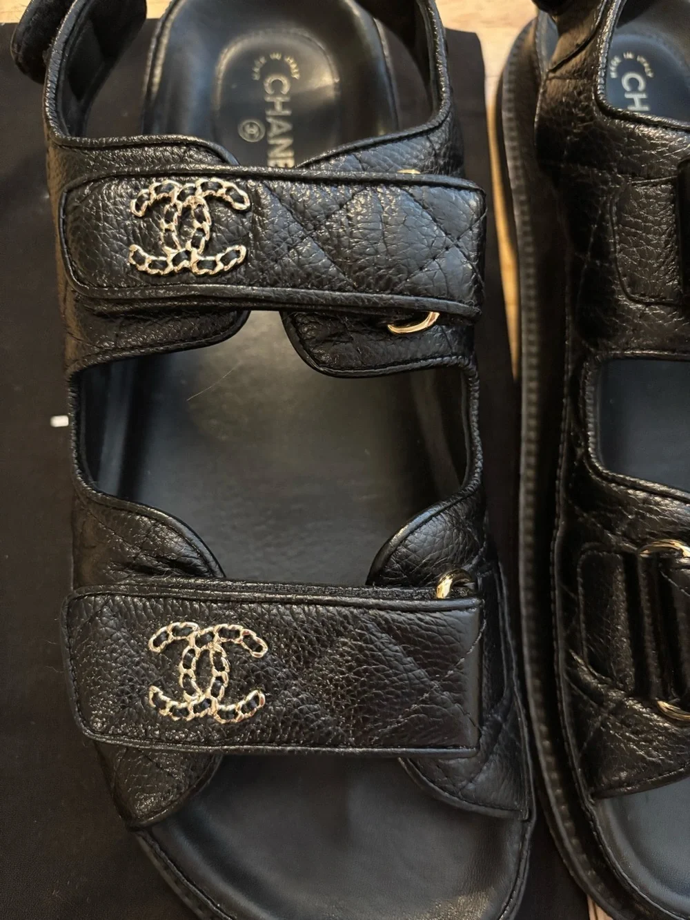 CHANEL Dad Black Leather Logo Strap Sandals with Gold CC Hardware.